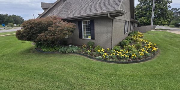 Residential home with landscaped flower beds and yellow flowers