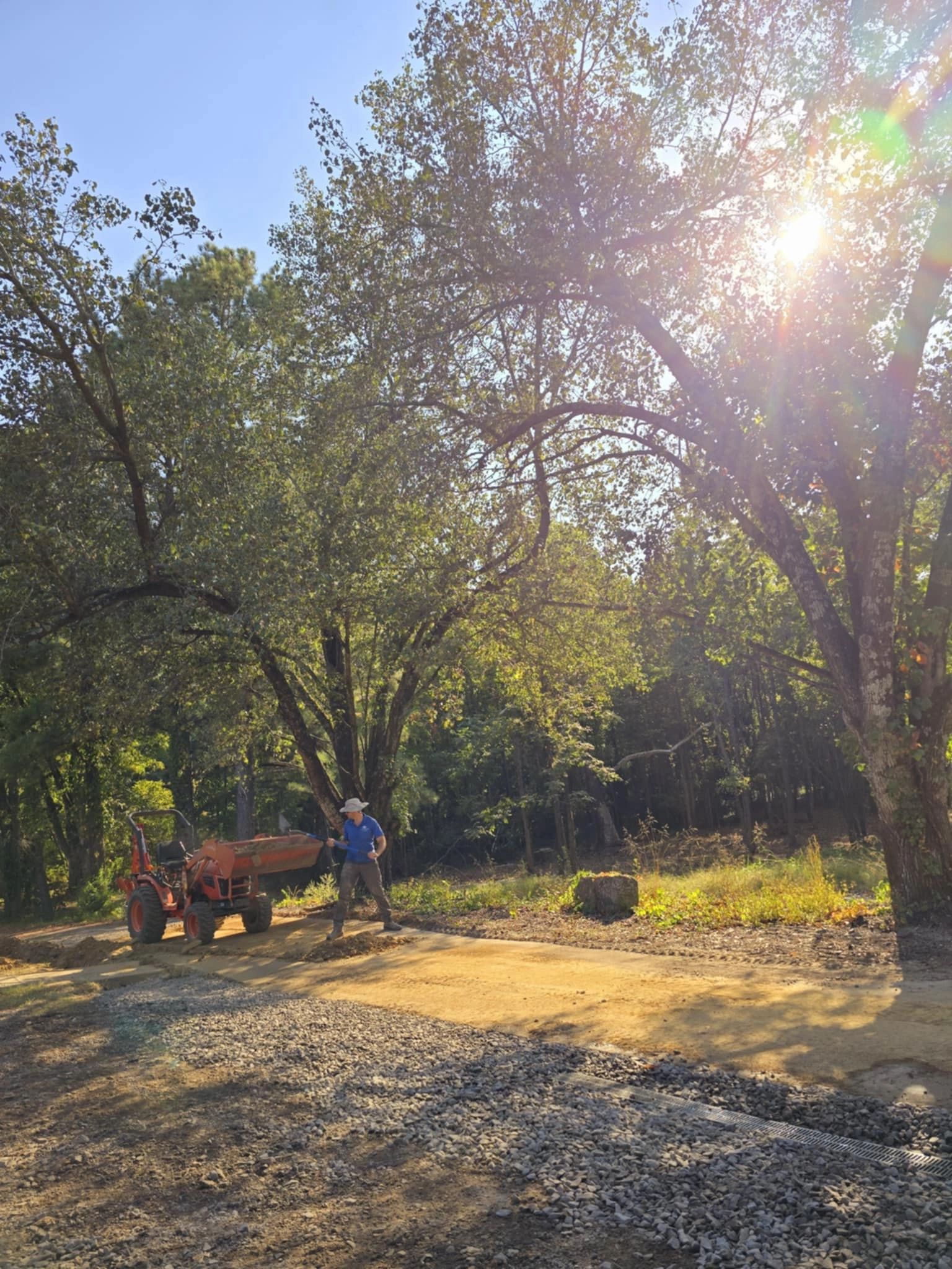 Person with tractor in rural outdoor setting